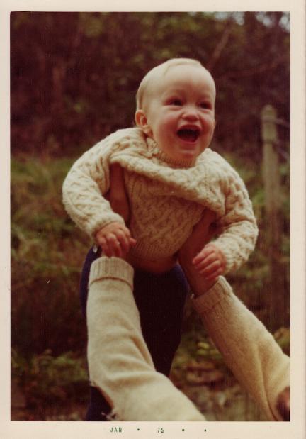 A bouncing baby LRG, held aloft by a pair of strong arms. Both are wearing heavy Arran sweaters. It was cold in the 70s.