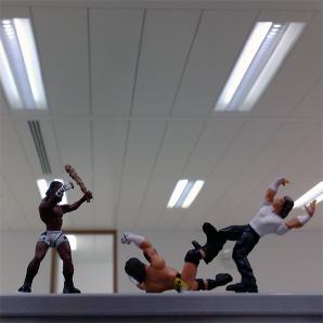 Some miniature wrestling figures battle it out.