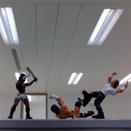 Some miniature wrestling figures battle it out.